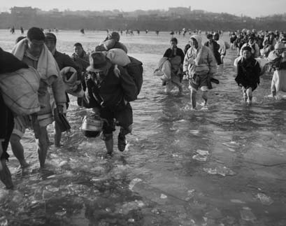 Koreans Fleeing Pyongyang braving the icy waters of the Taedong River.